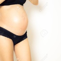 93937380-pregnant-belly-and-black-underwear-on-white-background