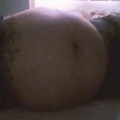 Lay on my side. Do I look pregnant.