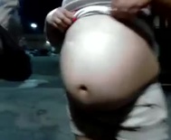 Big round pregnant belly rubbing