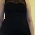 Looking pregnant in a dress.