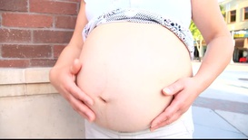 Pregnant woman on the sidewalk