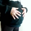 Pregnant woman in hooded sweatshirt