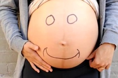 Smiling pregnant belly