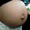 Hand circling her pregnant belly (Low)